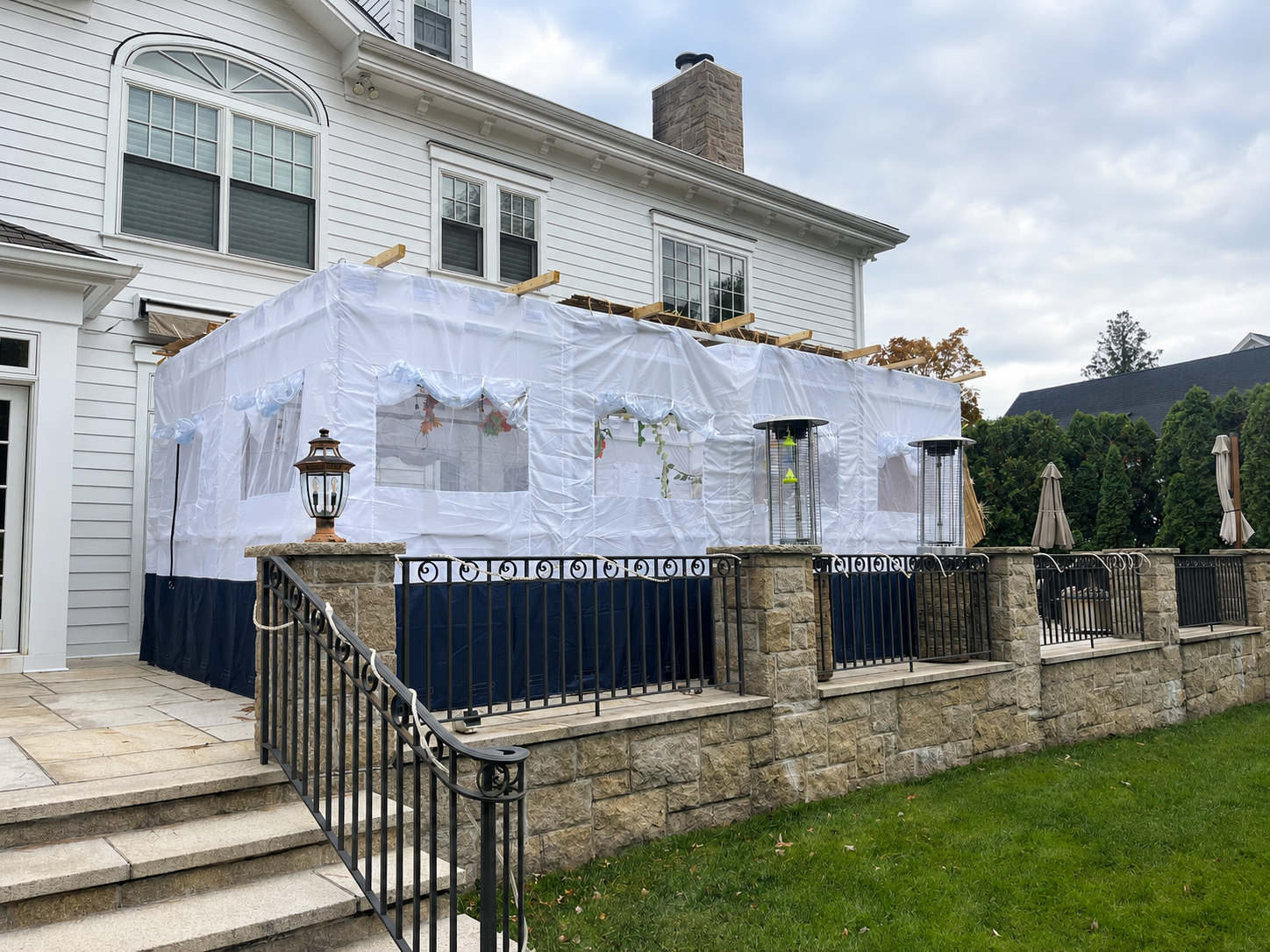 Interior dining setup inside a decorated rooftop sukkah